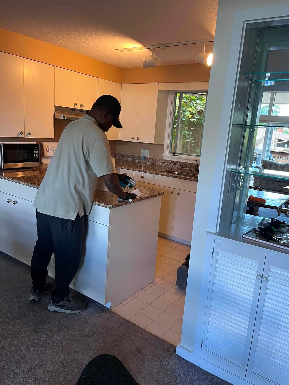 Crew member wiping down a kitchen island